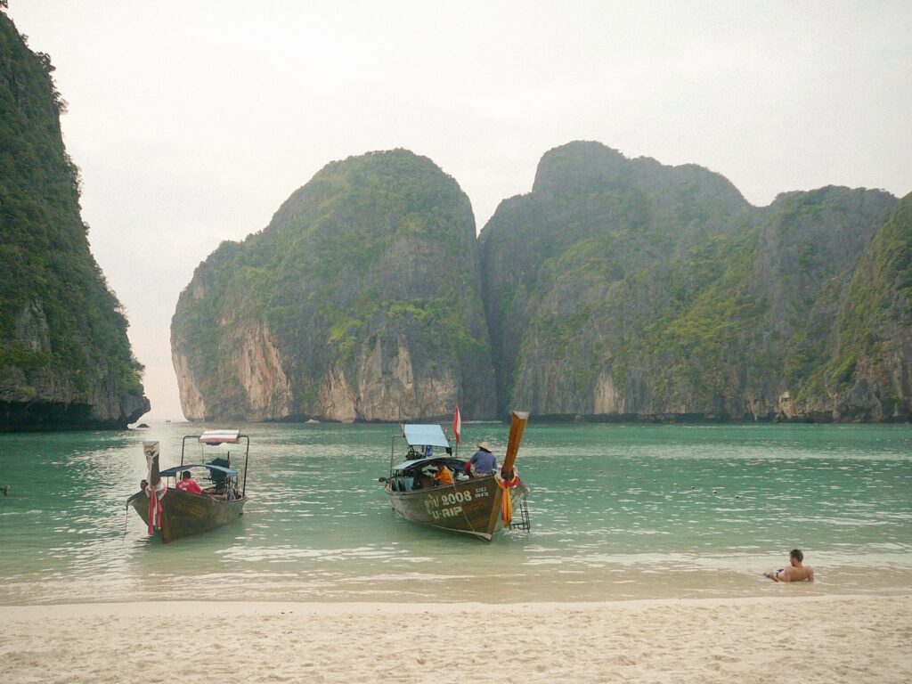 View from the beach across Maya Bay, with boats floating on the water